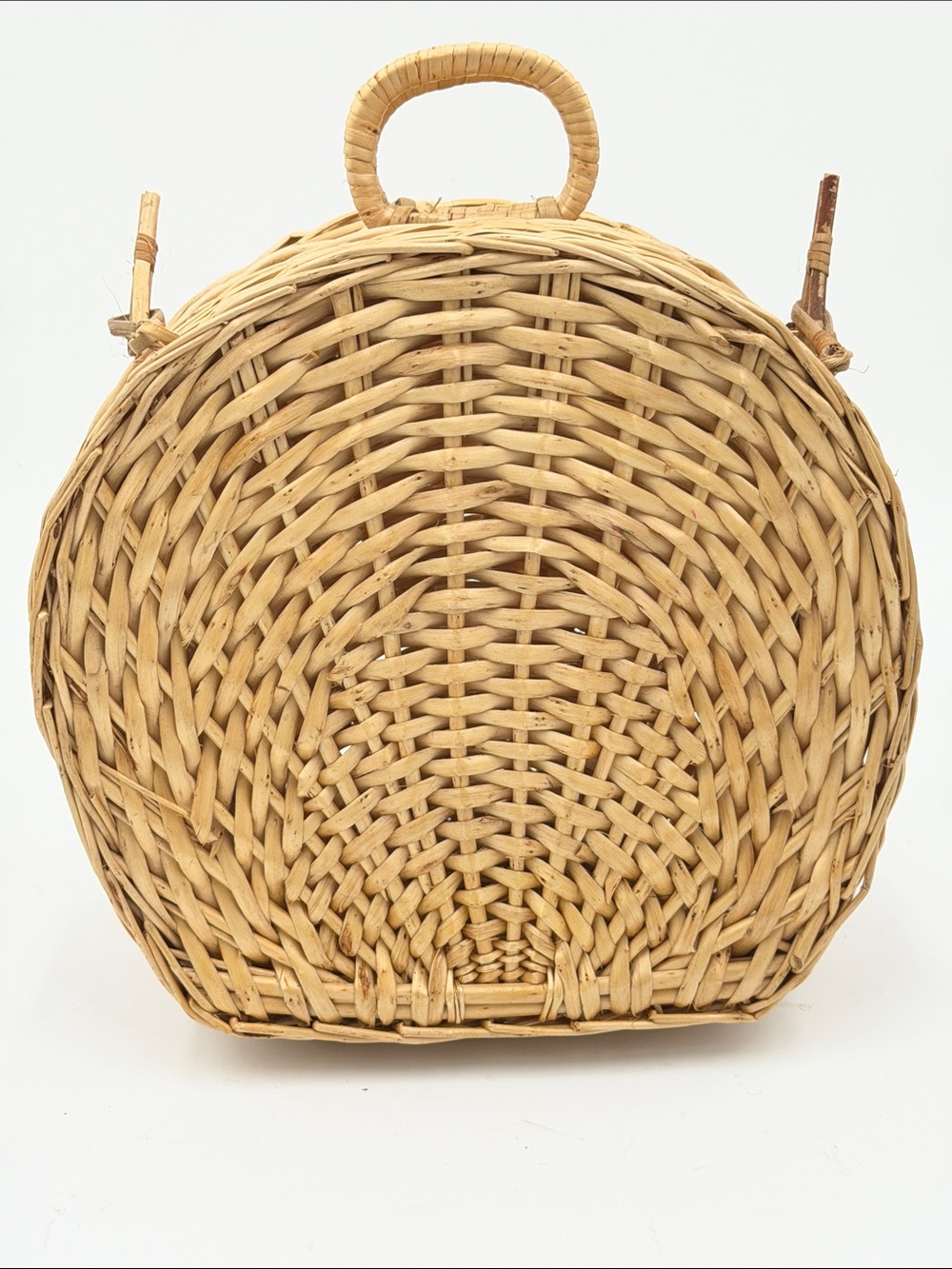 A Cute, charming vintage shell-shaped rattan storage basket with a front handle.